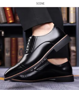 Detail of black leather oxford shoe with brogue punching and cap-toe stitching