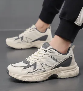 Close-up of men breathable mesh sports shoe with grey leather patchwork and thick sole