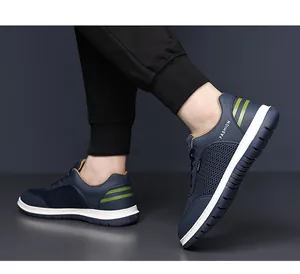 Detailed close-up of navy blue breathable mesh fabric and fashion text on men's sneaker