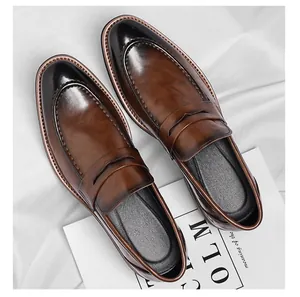 Top view of gradient brown leather loafers with detailed stitching and penny strap design
