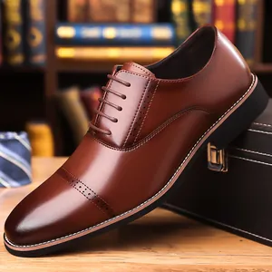 Formal brown leather oxford shoes for men with intricate brogue detailing and white stitching