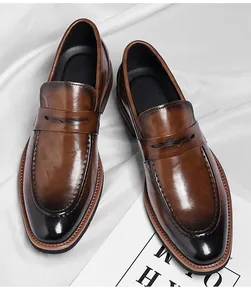 Detail of vintage brown leather loafers with burnished gradient finish and sleek penny strap
