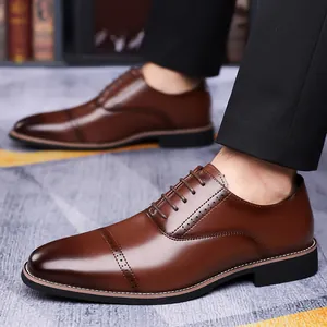 Brown brogue Oxford dress shoes for men with pointed cap toe and lace-up closure