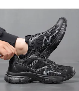 Detail of black breathable mesh shoe with leather panels and textured thick sole
