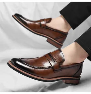 Detail of brown leather loafer with penny strap and polished toe for men
