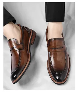 Top-down view of brown gradient leather loafers with classic penny strap and stitch details