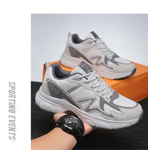 Detail of breathable mesh texture and dynamic M-stripe on gray athletic sneakers