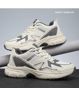 Close-up of thick soles and mesh fabric on cream and grey breathable dad sneakers