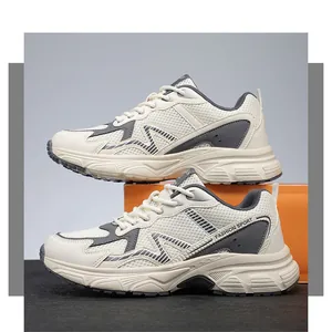 Detailed side view of cream and grey mesh sneakers with thick EVA sole and fashion sport text