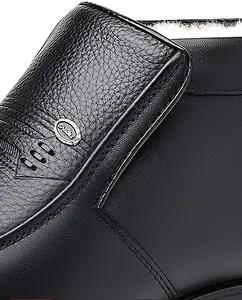 Detailed macro of men's leather winter boot with thick white plush lining and metal logo