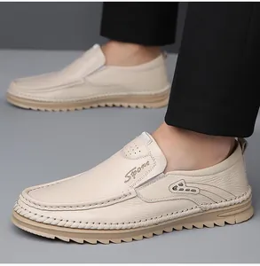 Detail of cream leather slip-on loafers with Sport embroidery and tan durable outsoles