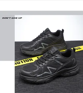 Macro detail of black breathable mesh sneakers with synthetic overlays and Z-shaped accents