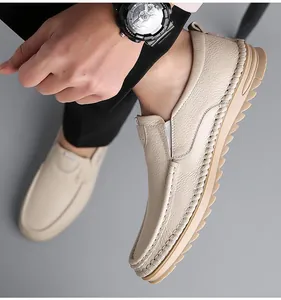 Macro shot of beige leather loafers featuring handcrafted stitching and thick rubber soles