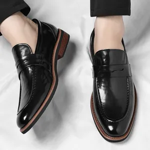 Formal black patent leather penny loafers for men with a soft brown contrast sole