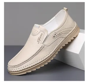 Detail view of beige leather loafers featuring Sport embroidery and textured finish