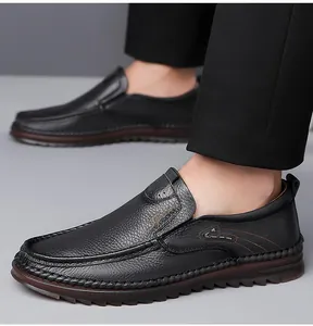 Detail of black pebbled leather loafers with sport logo and anti-slip rubber sole
