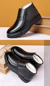 Detail of waterproof black leather men's winter boots with thick white faux fur lining