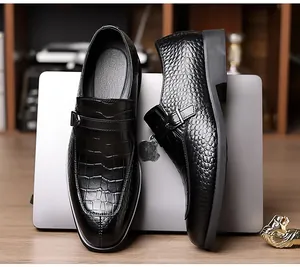 Detail of black crocodile texture leather and metal buckle on formal men's monk strap shoes
