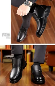 Detail of black leather men's warm winter shoes with textured surface and metal buckle