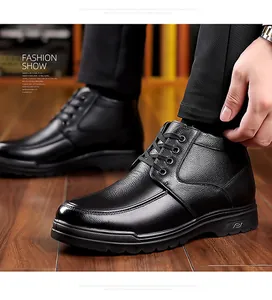 Detail of premium black leather men's winter boots featuring lychee grain and thick rubber soles