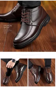 Detail view of brown leather men's boots showing lychee texture and durable rubber soles