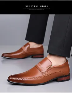 Detail of brown leather business loafers with embossed texture and woven stitching