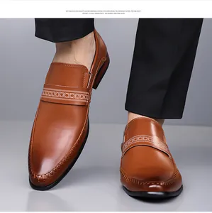 Detail of brown leather loafer featuring an embossed geometric band and premium finish
