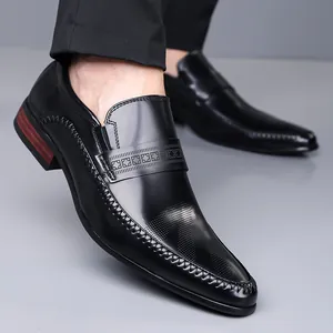 Polished black leather loafers for men with pointed toe and geometric textured strap detail