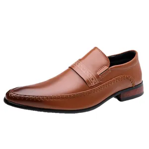 Men's brown pointed-toe dress shoes with refined stitching and decorative embossed strap