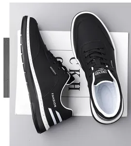 Top down view of black casual men's sneakers with fashion text and non-slip white soles