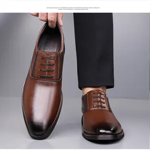 Close-up of brown men's oxford shoes with embossed crocodile texture and gradient leather