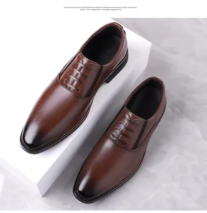 Detailed view of dark brown leather dress shoes with crocodile texture and gradient finish