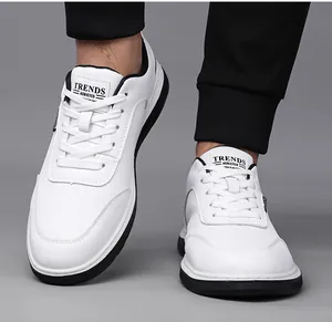 Detailed close-up of white leather sport shoe with mesh texture and black non-slip sole