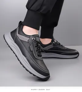 Detail of men's black leather sneakers showing fashion label and thick grey cushioned sole