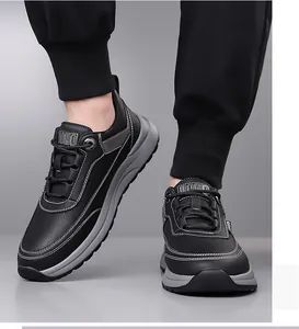Detail of men's black leather sneakers featuring white contrast stitching and UOMO label