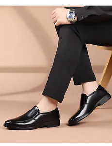 Side view of black business loafers with glossy leather and sport embossed detail