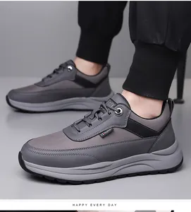 Detail of gray patchwork men's sneakers showing the FASHION woven tag and rubber sole