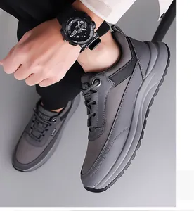 Side view detail of men's breathable grey sneakers with cushioned sole on feet