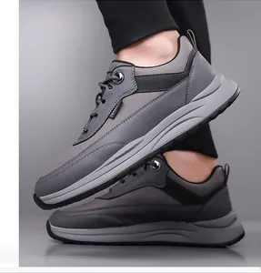 Close-up of gray patchwork men sneakers with mesh fabric and anti-slip thick soles