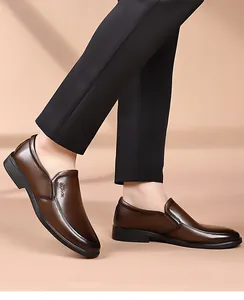 Detail of dark brown men's slip-on business shoes showing glossy finish and flexible sole