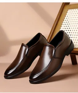 Detail view of brown leather slip-on shoe with embossed Sport logo and smooth texture