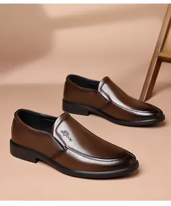 Detail view of brown slip-on leather shoe with Sport embossed logo and rubber sole