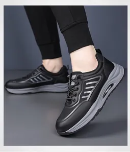 Detailed side view of grey and black casual sneakers with thick rubber soles and mesh details