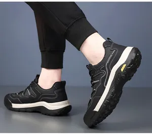 Macro view of black men's hiking shoes with durable deep-tread white soles