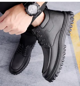 Detail of black pebbled leather texture and anti-slip thick rubber sole on men's boots