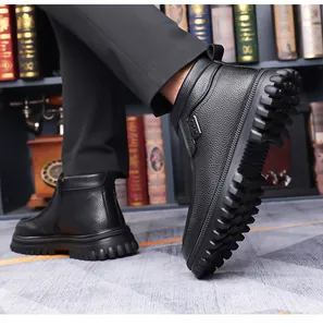 Close-up of black leather boots with thick non-slip rubber soles and sport label