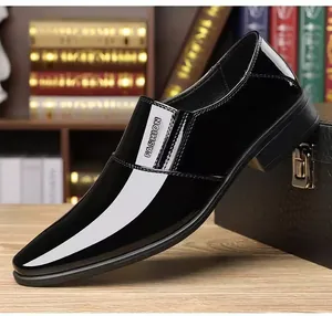 Detail of glossy black patent leather business shoes with side stripe fashion lettering