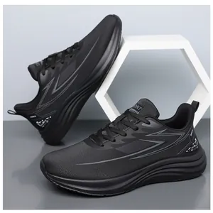 Detail of all-black athletic sneakers featuring mesh upper and wave-pattern thick sole