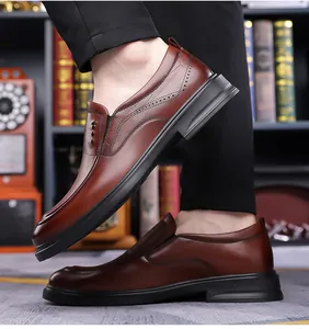 Detail view of brown crocodile texture leather and brogue stitching on men's business shoes