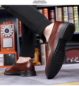 Close-up of brown leather loafers with brogue details and thick non-slip rubber soles
